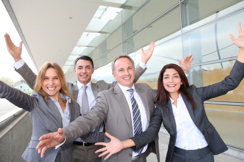 Stress management in the work place. 5 ways to handle stress. Image shows 4 partners excited and stress free.